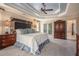 Bright main bedroom featuring french doors, carpet, a ceiling fan and an ensuite bathroom at 12350 Edenwilde Dr, Roswell, GA 30075