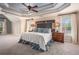 Spacious main bedroom with a tray ceiling, ceiling fan, carpet, and natural light from two windows at 12350 Edenwilde Dr, Roswell, GA 30075
