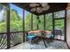 Relaxing screened porch with comfortable seating and a view of the lush backyard at 12350 Edenwilde Dr, Roswell, GA 30075