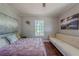 Cozy bedroom featuring hardwood floors, comfortable furnishings and natural light from the window at 1920 W Forrest Ave, Atlanta, GA 30344
