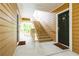 Building exterior featuring wood siding, staircase and entry doors with welcome mats at 225 Bentley Pl, Tucker, GA 30084
