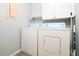 Dedicated laundry room area includes washer, dryer and storage shelving at 225 Bentley Pl, Tucker, GA 30084