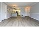 Open concept living room features wood-look floors, gray paint and view into the kitchen at 225 Bentley Pl, Tucker, GA 30084