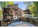 Exterior view from a multi-level deck surrounded by greenery and flowering bushes at 2683 Fleur De Lis Pl, Atlanta, GA 30360