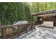 Relaxing back deck featuring a hot tub, seating, and views of bamboo trees at 2683 Fleur De Lis Pl, Atlanta, GA 30360