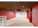The finished basement features a bar and unique lighting with red accent walls at 2683 Fleur De Lis Pl, Atlanta, GA 30360