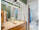 Bathroom vanity featuring a stone countertop, a large mirror with track lighting, and a view into the main bedroom at 2683 Fleur De Lis Pl, Atlanta, GA 30360