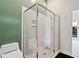 Bathroom with glass enclosed shower, toilet, and view into an adjacent room through an open door at 2683 Fleur De Lis Pl, Atlanta, GA 30360