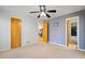 Spare bedroom featuring a ceiling fan and access to adjacent rooms through doorways at 2683 Fleur De Lis Pl, Atlanta, GA 30360