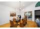 The dining room features a contemporary light fixture, ample seating, and sliding doors to the outside at 2683 Fleur De Lis Pl, Atlanta, GA 30360