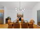Dining area with modern light fixture, seating for six, and flows into the kitchen area at 2683 Fleur De Lis Pl, Atlanta, GA 30360