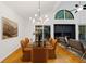 Dining room boasts modern light fixture, seating for six, and access to the outdoor living space at 2683 Fleur De Lis Pl, Atlanta, GA 30360