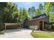 Contemporary home with carport, clean lines, and surrounding landscaping at 2683 Fleur De Lis Pl, Atlanta, GA 30360
