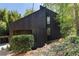 Modern home exterior with unique architectural details and natural wooded surroundings at 2683 Fleur De Lis Pl, Atlanta, GA 30360