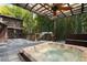 An outdoor hot tub area creates an idyllic setting to relax and enjoy nature at 2683 Fleur De Lis Pl, Atlanta, GA 30360