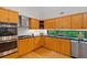 Bright kitchen featuring wood cabinets, stainless steel appliances, and a garden view window at 2683 Fleur De Lis Pl, Atlanta, GA 30360