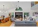 Stylish open-concept living room with a fireplace, modern furnishings, and hardwood floors at 2683 Fleur De Lis Pl, Atlanta, GA 30360