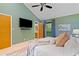 This main bedroom features vaulted ceilings, a ceiling fan, a wall-mounted television and ensuite bathroom access at 2683 Fleur De Lis Pl, Atlanta, GA 30360