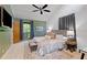 Brightly lit main bedroom featuring a plush bed, ceiling fan, and a door to the en suite at 2683 Fleur De Lis Pl, Atlanta, GA 30360