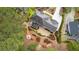 Aerial view of backyard featuring hot tub, patio seating, and manicured landscaping at 8920 Willowbrae Ln, Roswell, GA 30076