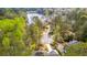 An aerial view shows a home on a wooded lot near a lake at 8920 Willowbrae Ln, Roswell, GA 30076