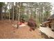 Stone patio in wooded backyard with two chairs at 8920 Willowbrae Ln, Roswell, GA 30076