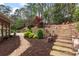 Backyard featuring mulched flower beds, stone steps, and gravel walkways at 8920 Willowbrae Ln, Roswell, GA 30076