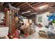 Unfinished basement featuring storage areas, tools, and exterior door at 8920 Willowbrae Ln, Roswell, GA 30076