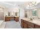 Bright bathroom featuring double sinks, wood cabinets, and a luxurious tub at 8920 Willowbrae Ln, Roswell, GA 30076