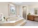 A relaxing tub with a unique stained glass window provides a tranquil bathroom at 8920 Willowbrae Ln, Roswell, GA 30076