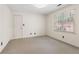 A carpeted bedroom features neutral paint, a double window, and a white door at 8920 Willowbrae Ln, Roswell, GA 30076