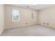 A carpeted bedroom features neutral paint, a double window, and a white door at 8920 Willowbrae Ln, Roswell, GA 30076