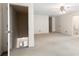 Spacious carpeted bedroom with a ceiling fan, two doors, and a neutral color scheme at 8920 Willowbrae Ln, Roswell, GA 30076