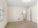 A carpeted bedroom with neutral paint with an open door leading to the hall at 8920 Willowbrae Ln, Roswell, GA 30076
