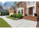 A close up of a brick home's entryway, showing a lush lawn and landscaping at 8920 Willowbrae Ln, Roswell, GA 30076