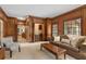 Inviting living room with beautiful paneled walls, plush seating, and ample natural light at 8920 Willowbrae Ln, Roswell, GA 30076
