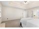 Spacious main bedroom featuring a tray ceiling and an en-suite bathroom with a soaking tub at 8920 Willowbrae Ln, Roswell, GA 30076