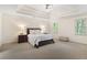 Serene main bedroom showcasing a tray ceiling, large windows, and a calming neutral color palette at 8920 Willowbrae Ln, Roswell, GA 30076