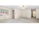 A well-lit carpeted main bedroom features a single window, a door, and ceiling fan at 8920 Willowbrae Ln, Roswell, GA 30076