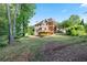 Spacious backyard featuring a deck, screened in porch, patio and mature landscaping at 915 Summer Wind Pl, Roswell, GA 30075