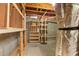Unfinished basement space for storage with exposed beams, piping, shelving, and cement floor at 915 Summer Wind Pl, Roswell, GA 30075