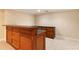 Basement area with tile floors, custom wooden bar, and natural light from a window at 915 Summer Wind Pl, Roswell, GA 30075