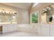 Bright bathroom featuring a soaking tub, dual vanities, and large windows offering natural light at 915 Summer Wind Pl, Roswell, GA 30075