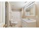 Bathroom with a tub and shower, white vanity, and a toilet, illuminated by modern vanity lighting at 915 Summer Wind Pl, Roswell, GA 30075