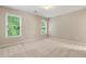 Bright and spacious bedroom with neutral carpet, two windows, and ample natural light at 915 Summer Wind Pl, Roswell, GA 30075
