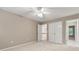 Neutral bedroom featuring ceiling fan and entrances to hallway and a double door closet at 915 Summer Wind Pl, Roswell, GA 30075
