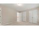 Cozy bedroom with neutral walls, carpeted floor, a double closet and access to the staircase at 915 Summer Wind Pl, Roswell, GA 30075