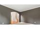 Bedroom with neutral walls, carpet and view through archway into foyer with stairs at 915 Summer Wind Pl, Roswell, GA 30075