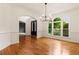 Bright dining room with hardwood floors, large windows and view to front entry at 915 Summer Wind Pl, Roswell, GA 30075