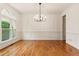 Elegant dining room with hardwood floors, large windows, and modern chandelier at 915 Summer Wind Pl, Roswell, GA 30075